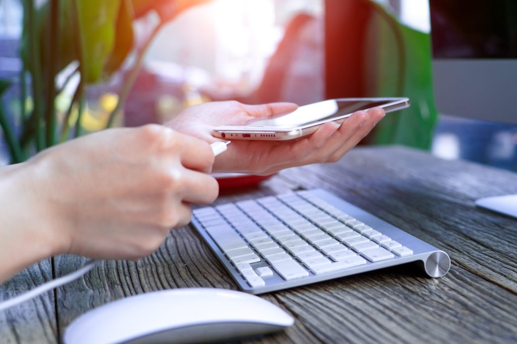 Someone charging phone at desk